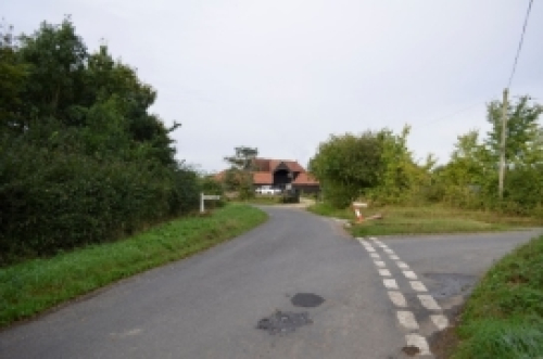 A road with a house on the side

Description automatically generated with low confidence